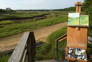 Painting easel set up on the edge of a marsh