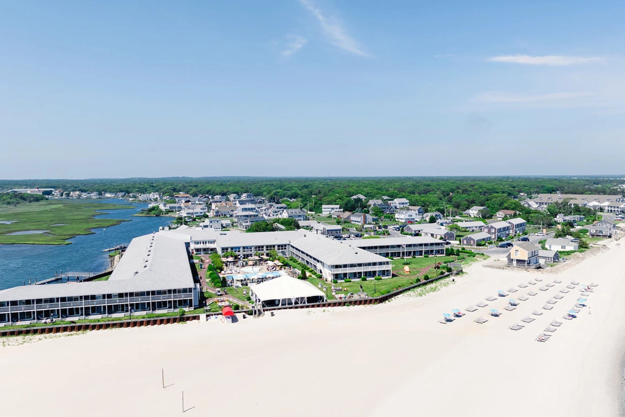 Coastal resort by the beach under a clear blue sky.