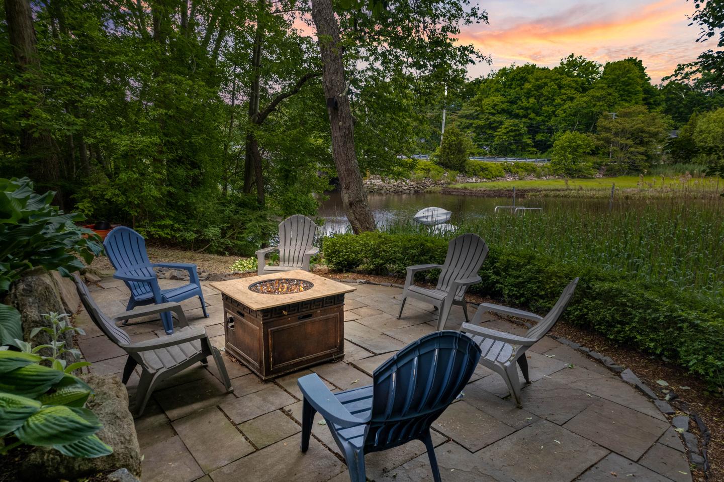 Image of Adirondak Chairs and firepit over looking the Patchogue River In Westbrook CT