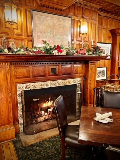 Cozy room with a lit fireplace and decorated mantel.