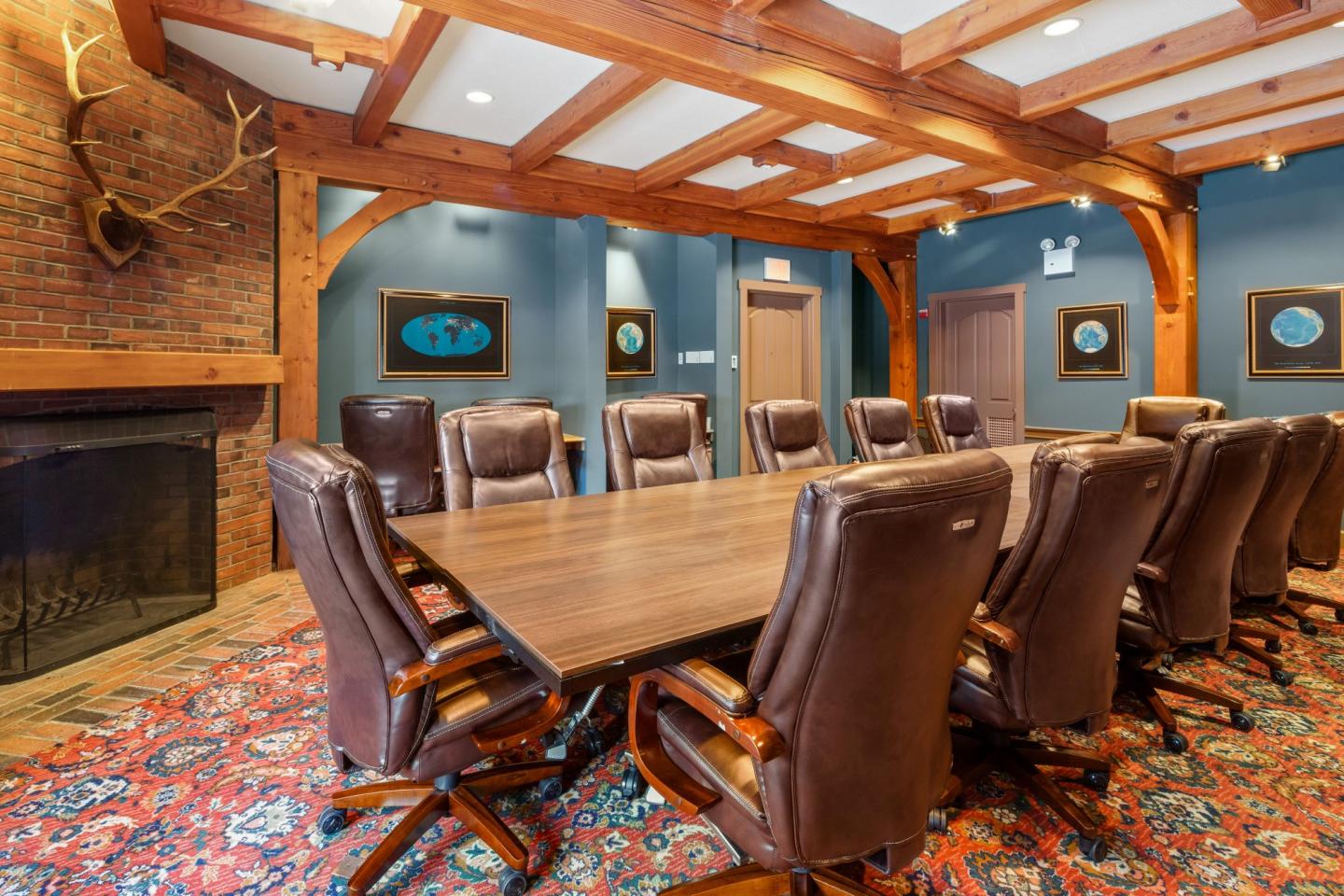 Wood-paneled conference room with a long table and leather chairs.