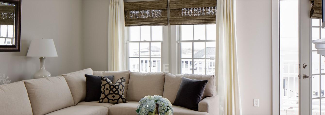 Cream sofa with patterned pillows in a bright, cozy living room.