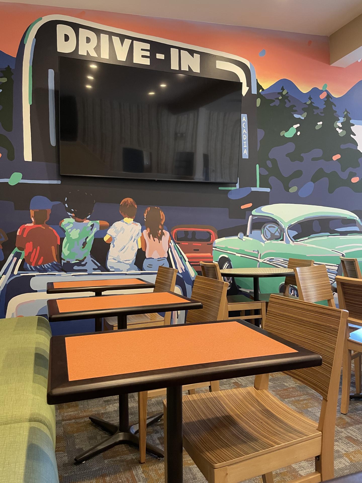 Retro diner mural with drive-in scene, colorful cars and tables 