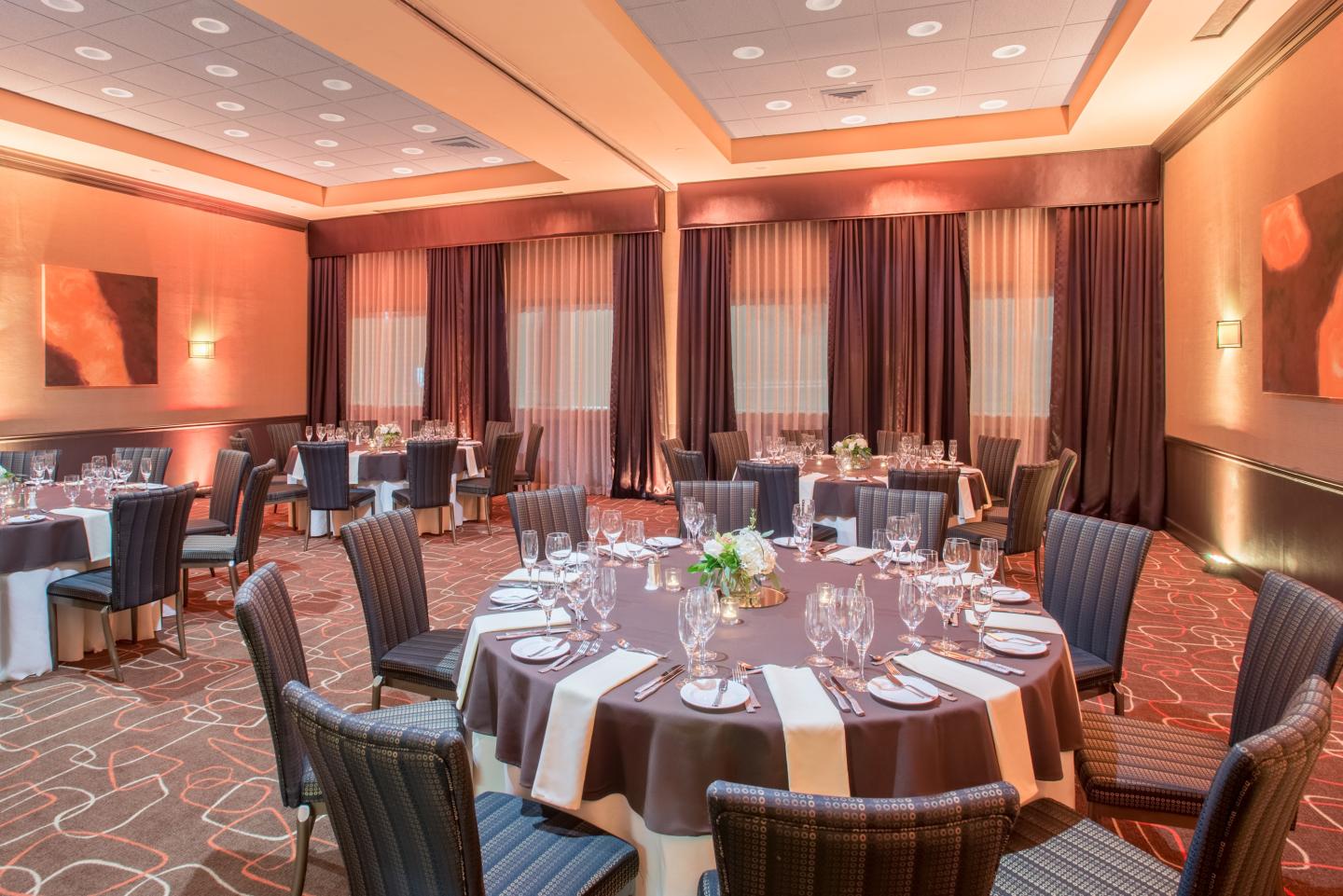 Elegant banquet hall with round tables, set for an event.
