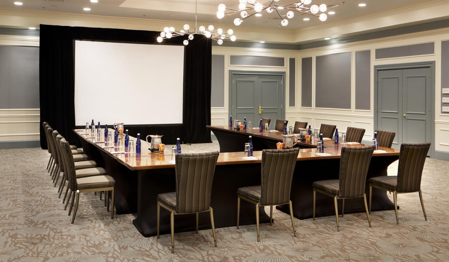 U-shaped conference table with chairs in a modern meeting room.