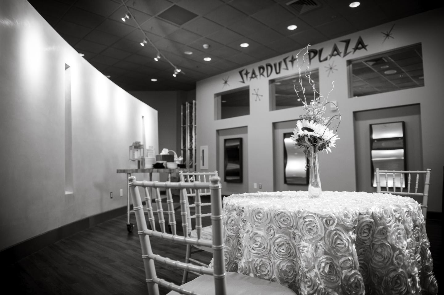 Elegant black and white room with decorated table and chairs.