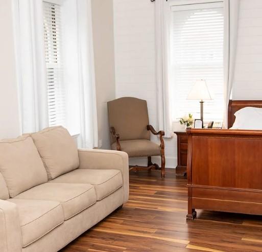 Beige sofa and armchair in a cozy room with hardwood floors.