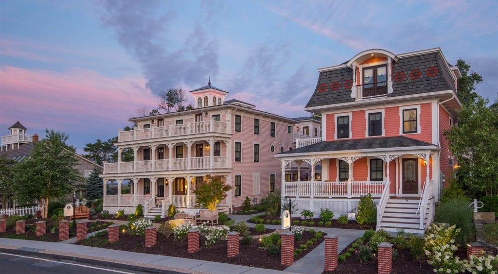 Victorian-style houses with porches at sunset.