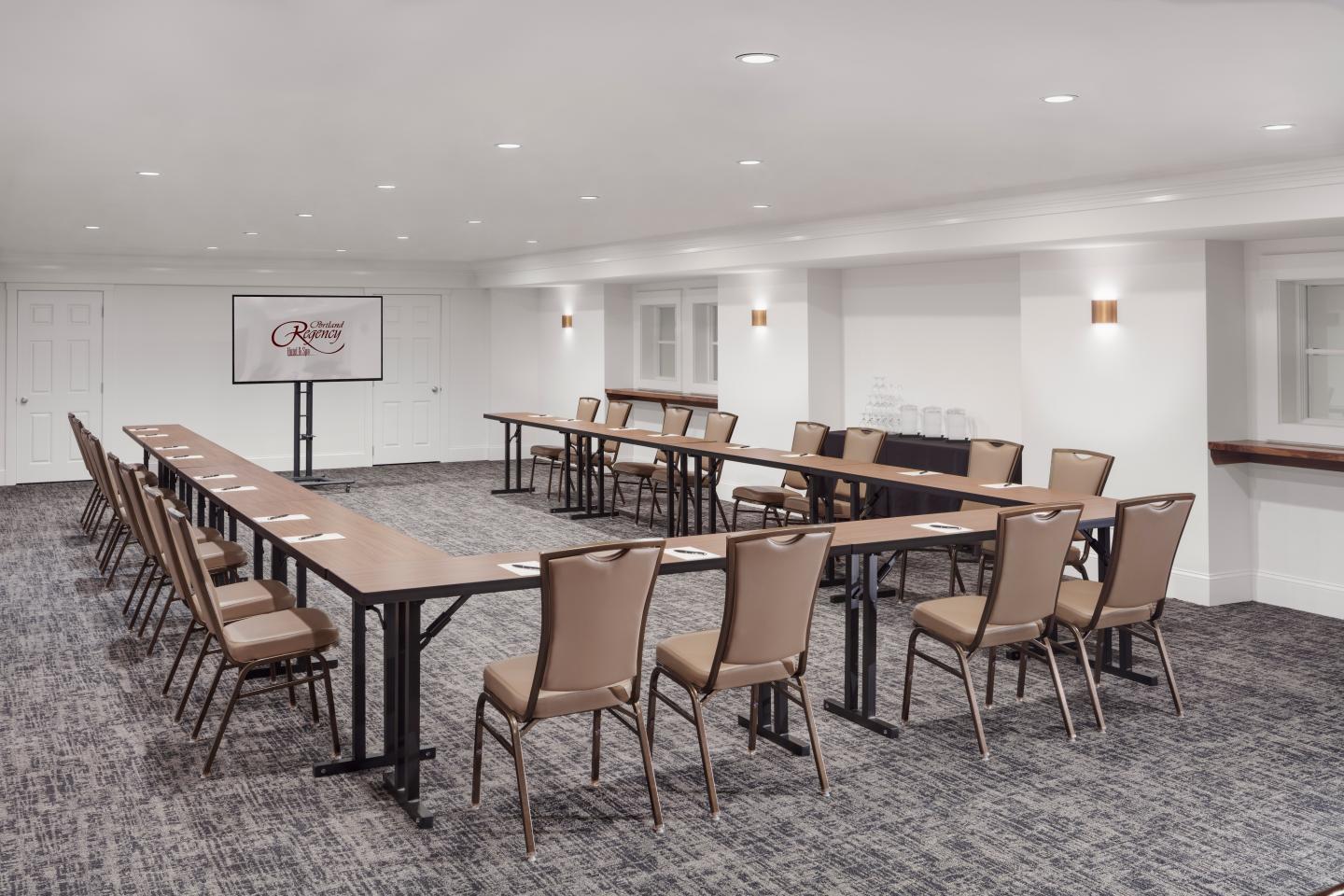 Meeting room set in a u-shape with TV