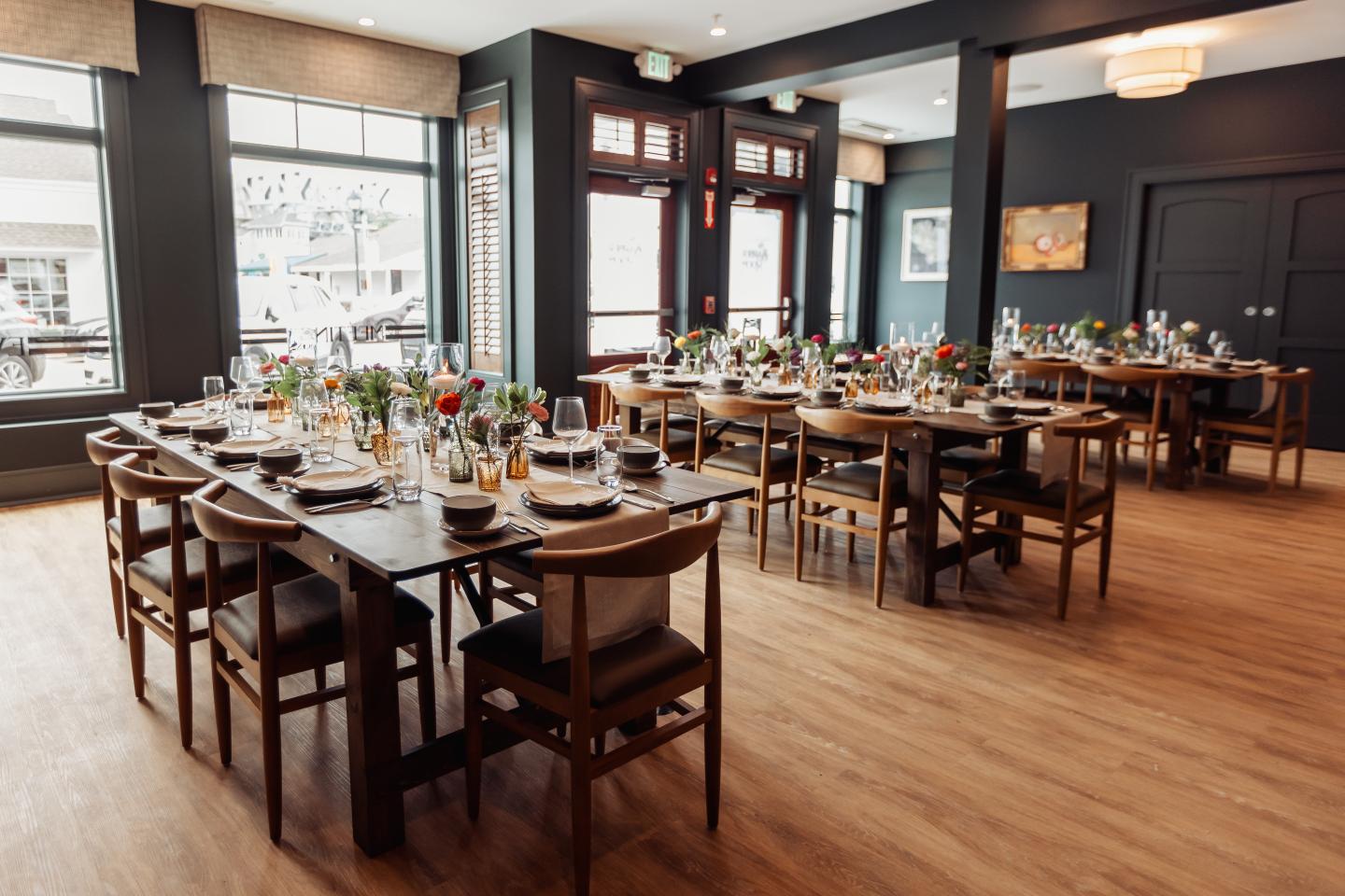 Spacious restaurant with set tables and large windows.