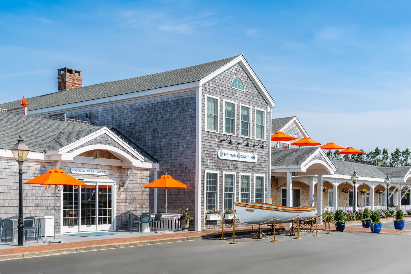 Hotel with orange umbrellas, and a boat display.