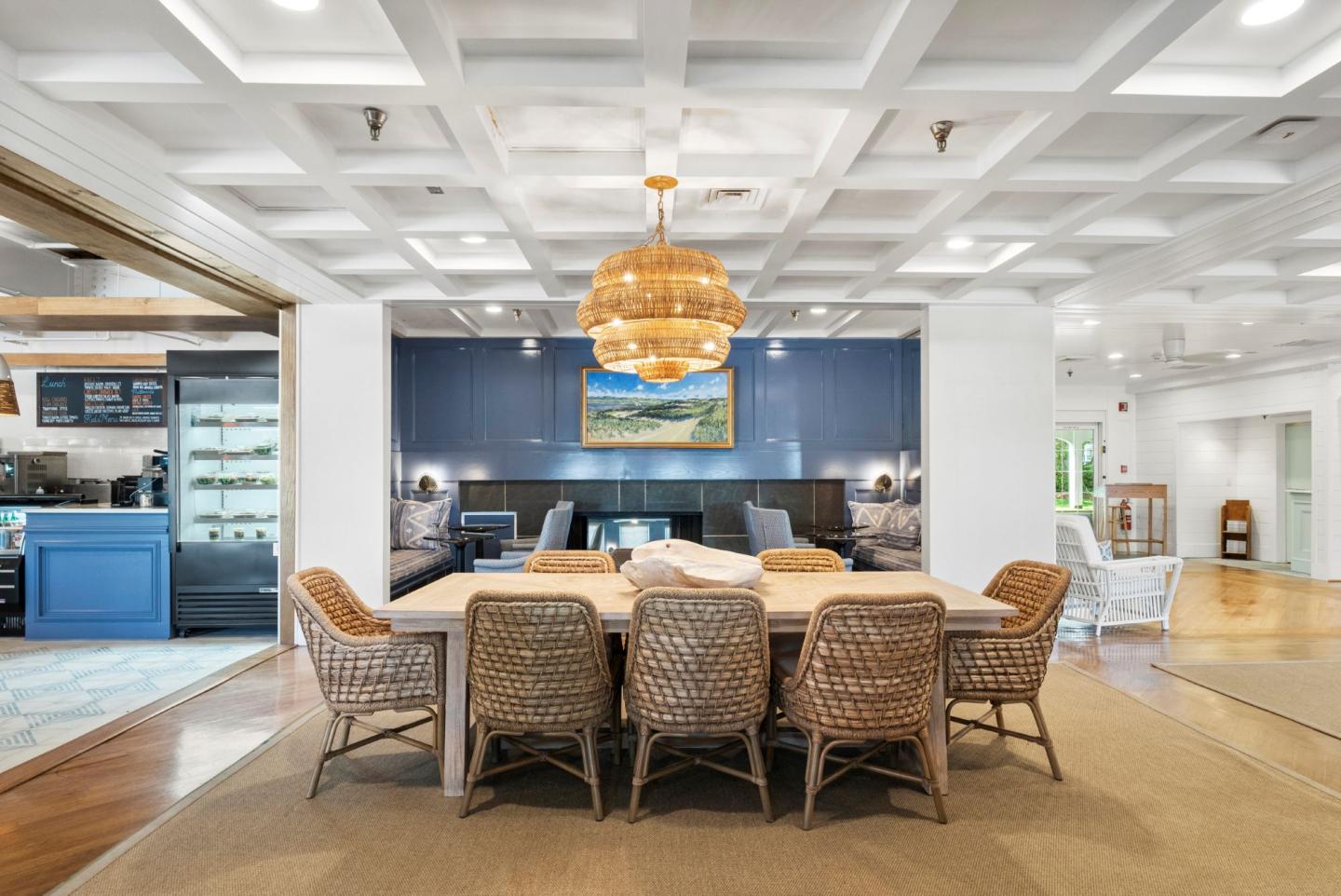 Cozy dining area with wicker chairs and a warm pendant light.