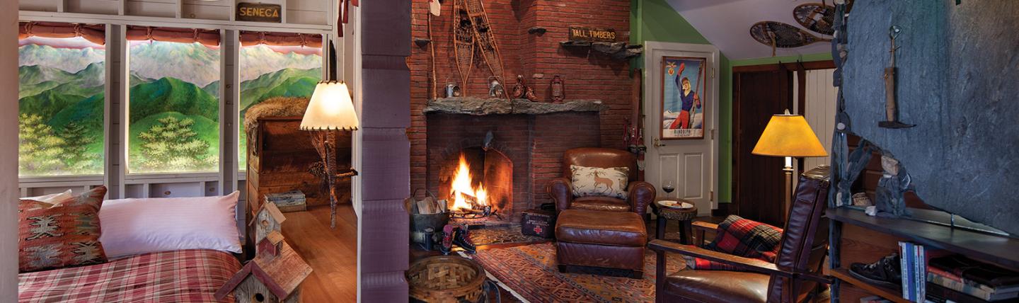 Cozy living room with fireplace, sofas, and warm lighting.