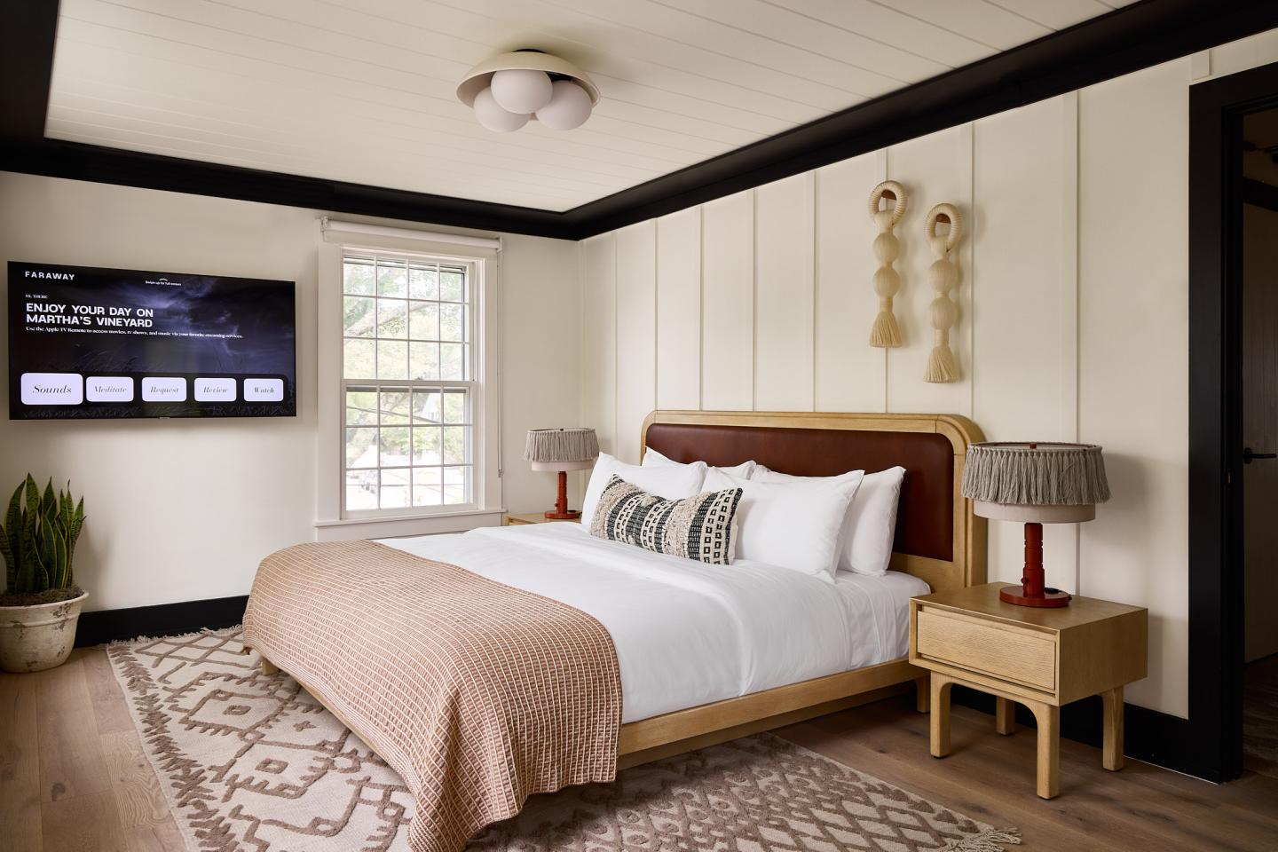Cozy bedroom with a large bed, bedside tables, and a wall-mounted TV.