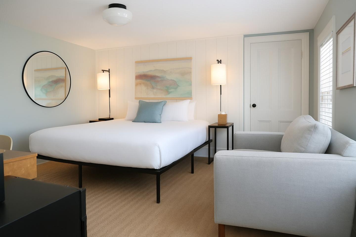 Modern bedroom with a large bed, soft lighting, and neutral colors.