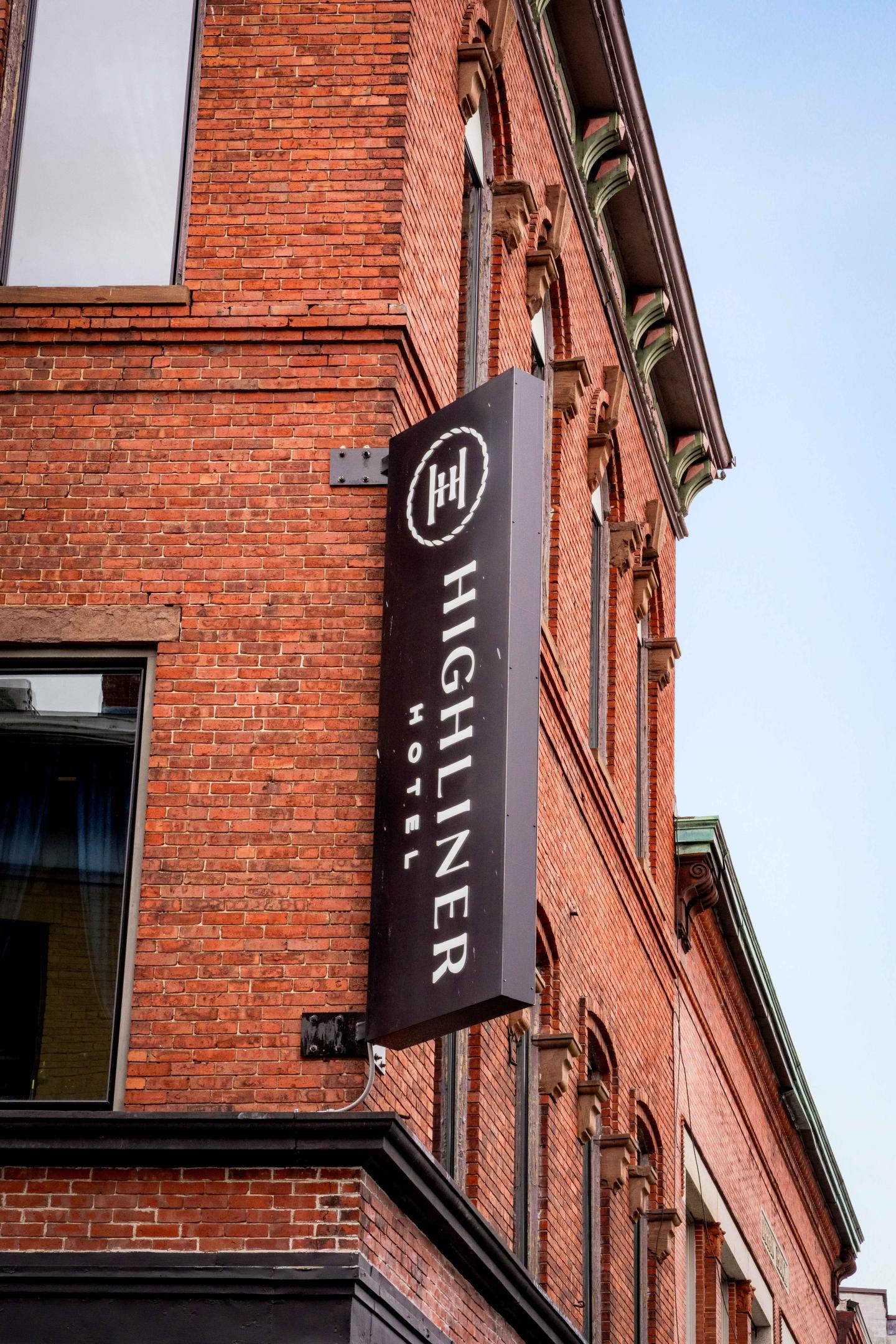 Red brick building with a "Highliner Hotel" sign.