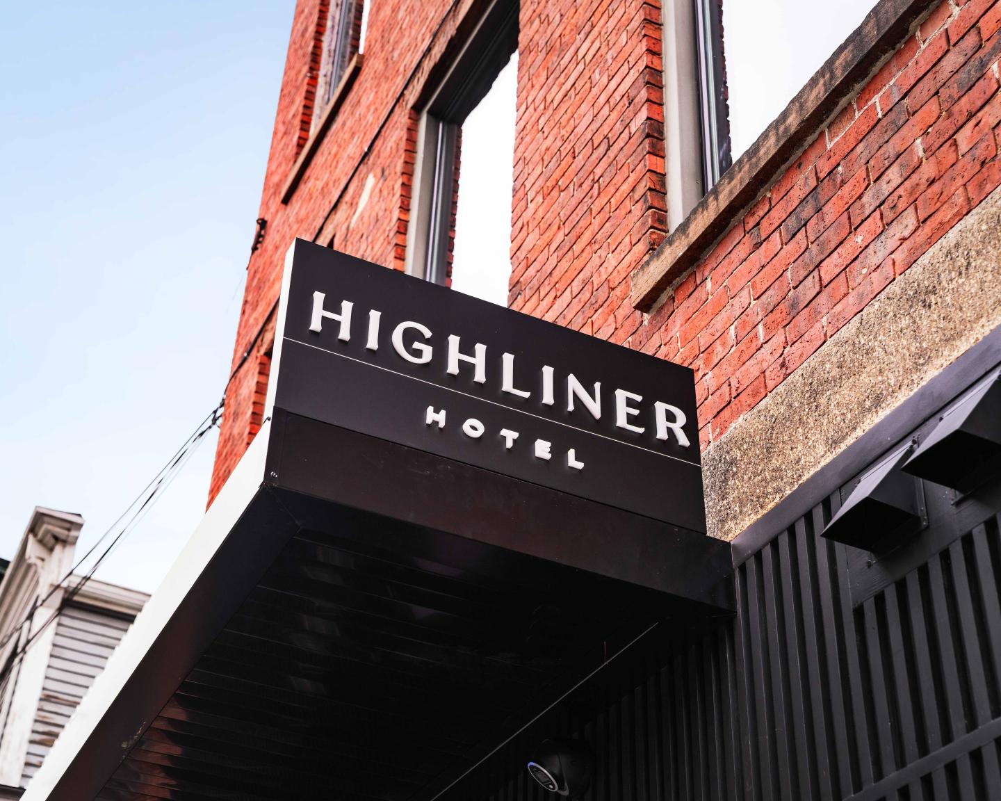 Highliner Hotel sign on a brick building.