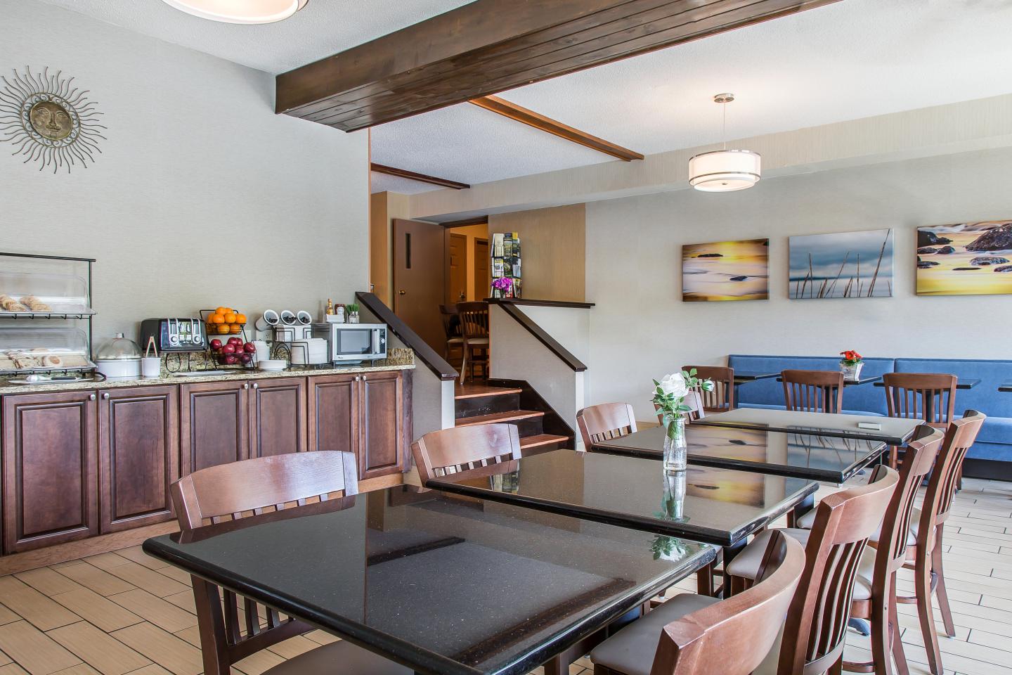 Cozy cafe with wooden tables, chairs, and wall art.