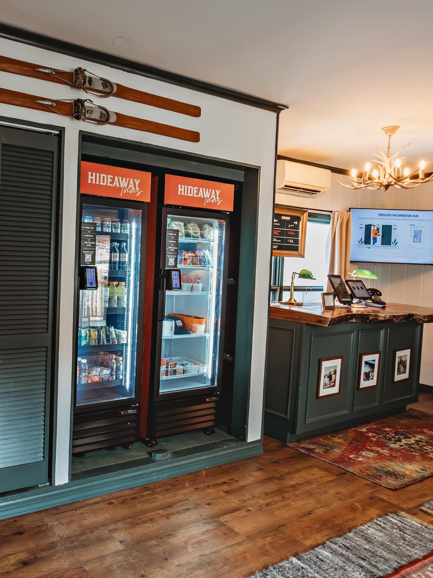 Convenience store interior with glass-door refrigerators and a counter.