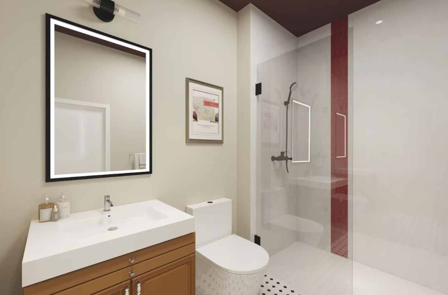 Modern bathroom with a shower, sink, mirror, and toilet.