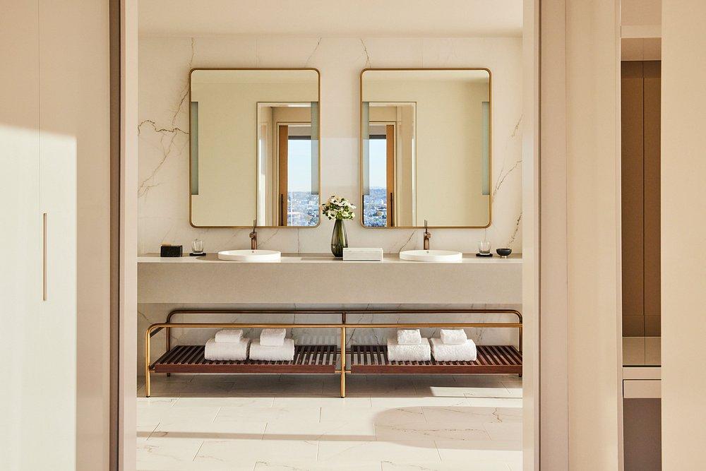 Luxurious bathroom with two sinks and large mirrors.
