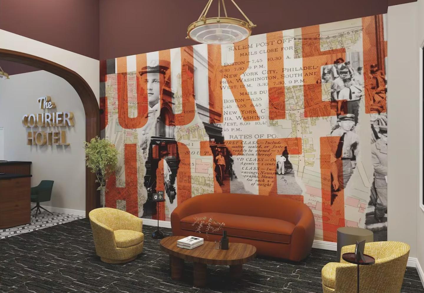 Hotel lobby with modern decor, mural, and orange sofa.