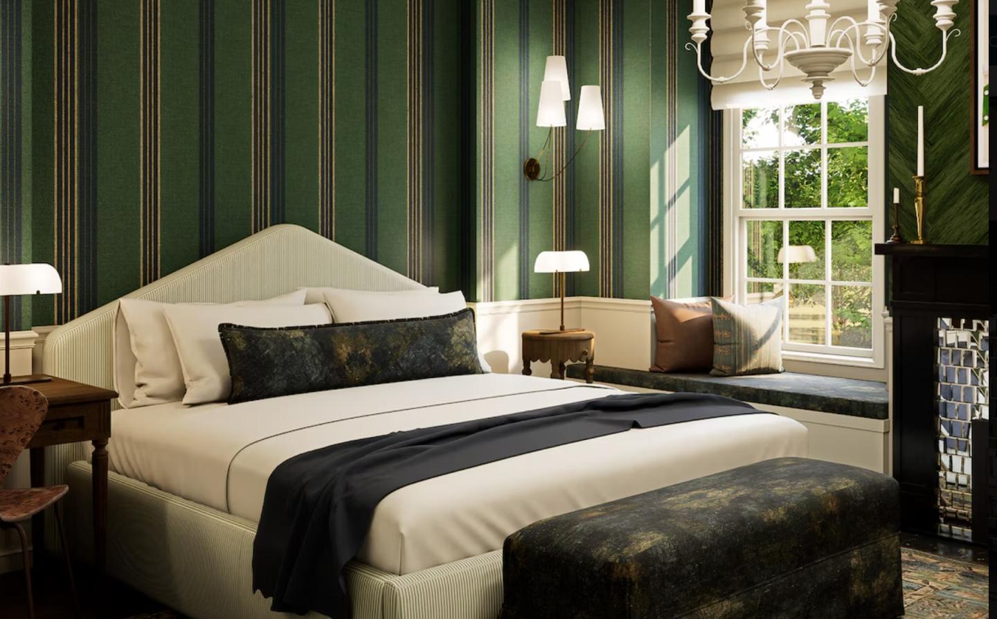 Elegant bedroom with striped wallpaper, a large bed, and a window with greenery outside.