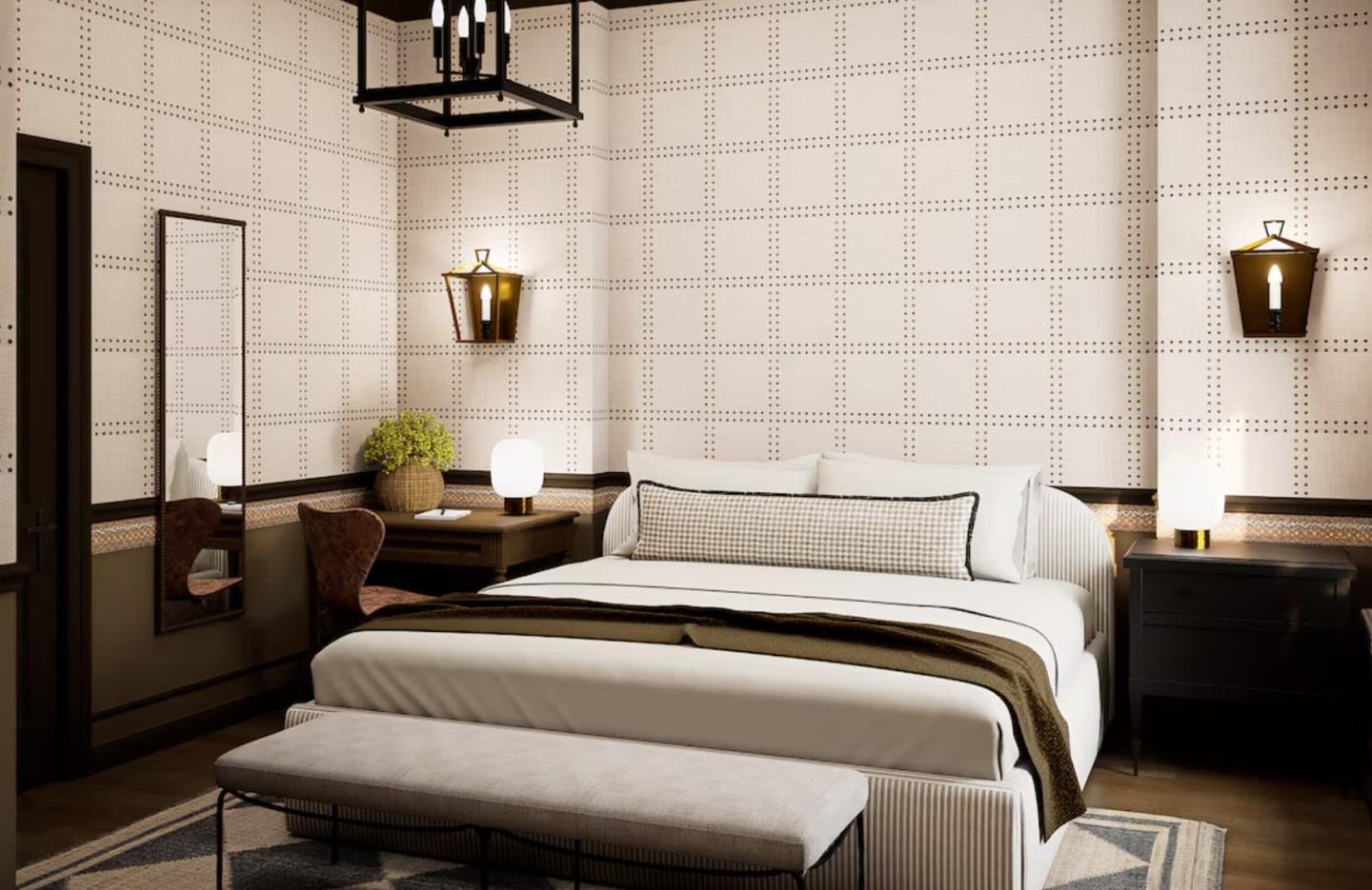 Cozy bedroom with king bed, wall lights, desk, and neutral tones.