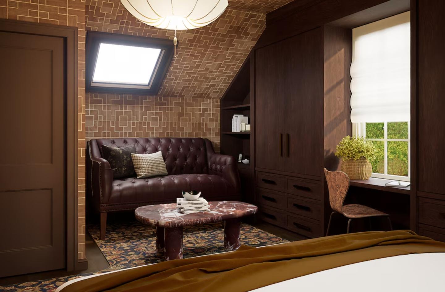 Cozy attic room with a brown sofa, wooden desk, and skylight window.
