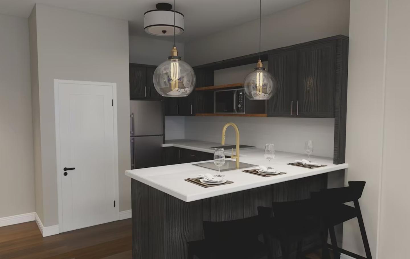 Modern kitchen with dark cabinets, white countertops, and pendant lights.