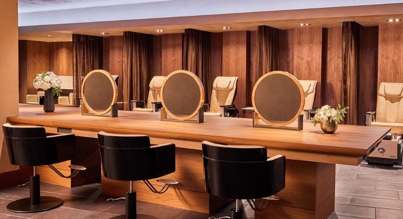 Modern salon with styling chairs, mirrors, and ambient lighting.