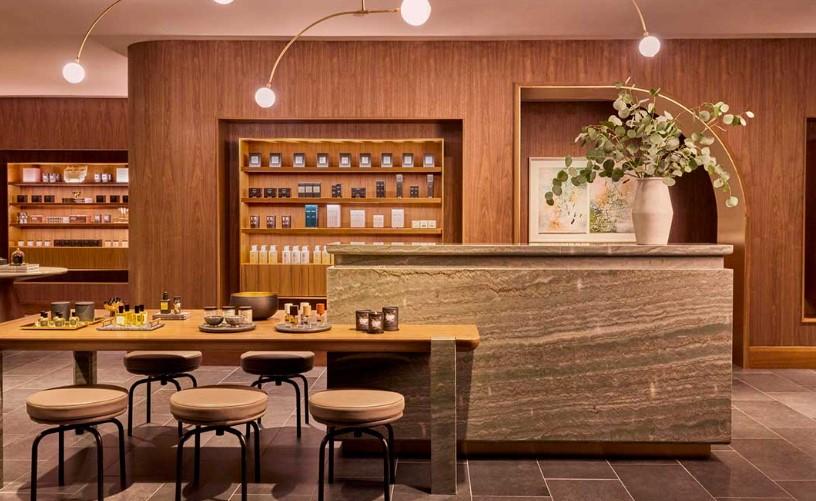 Warm, modern shop interior with wooden shelves and a stone counter.