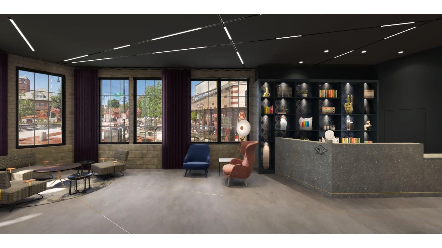 Modern lobby with large windows, seating, and a reception desk.