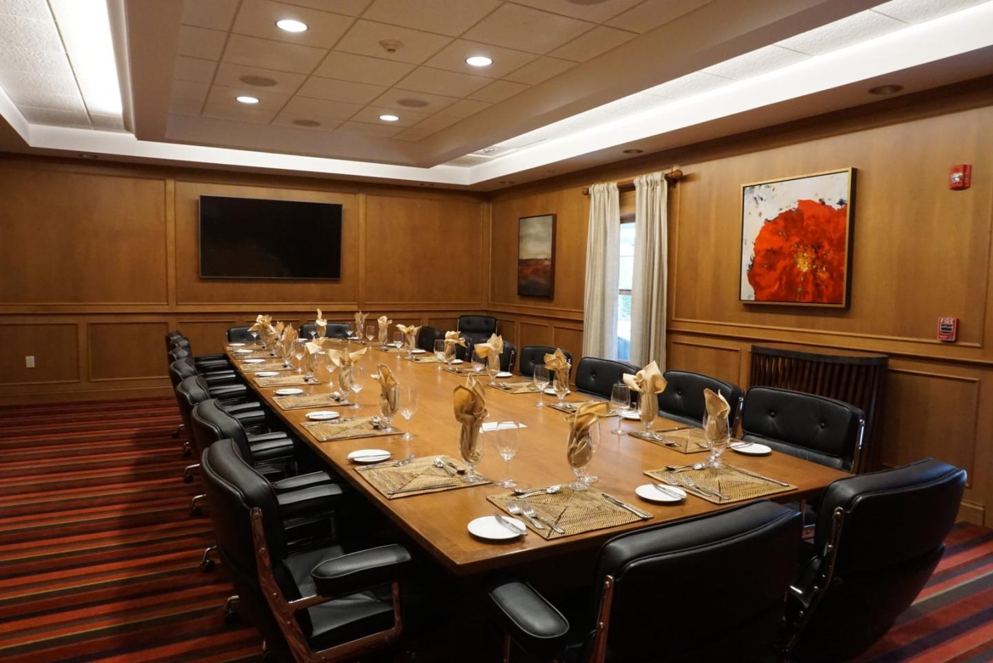 Elegant conference room with a long table set for a meeting.