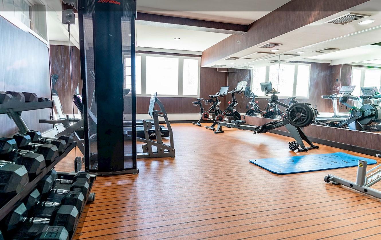 Fitness room with exercise machines and free weights.