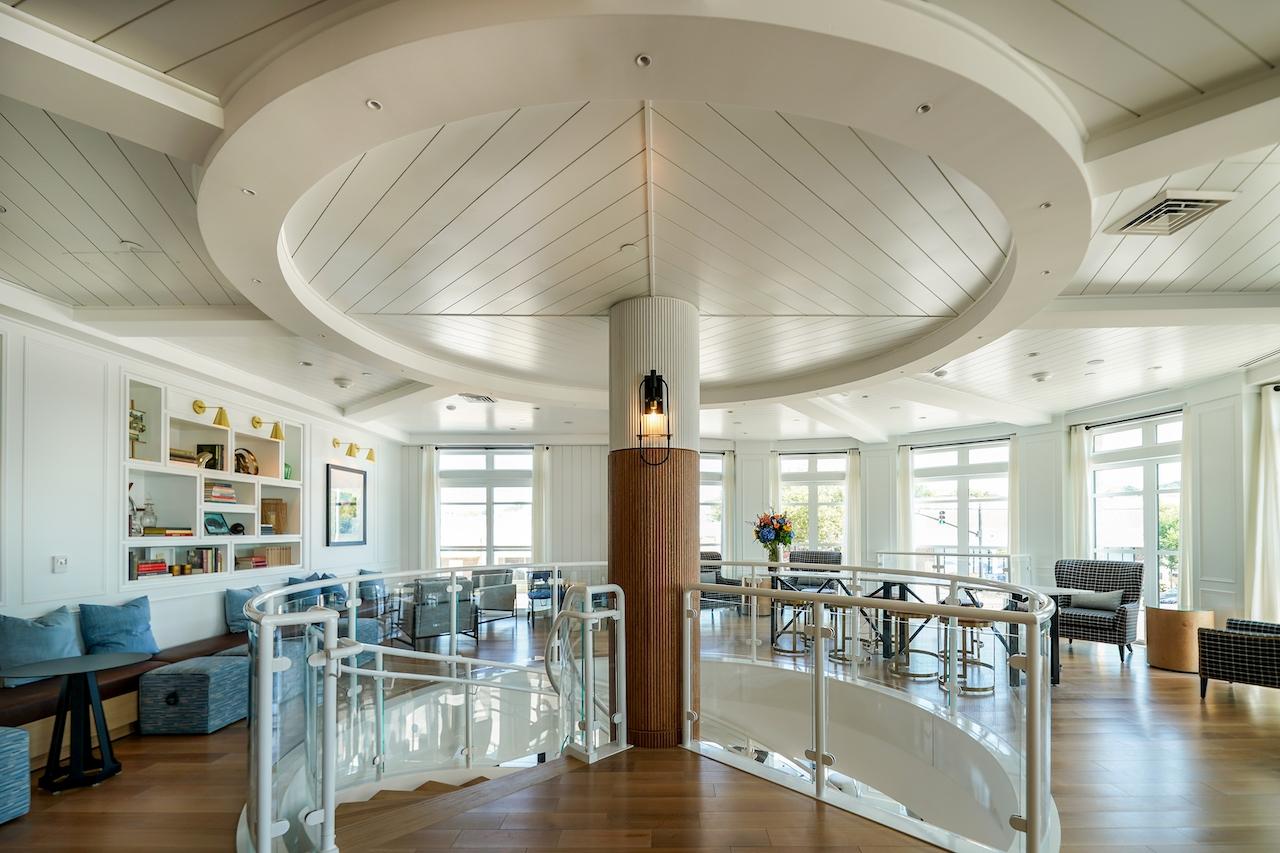 Spacious, bright room with circular ceiling and modern decor.