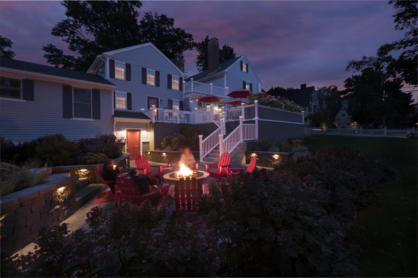 Fire pit and side of inn at dusk