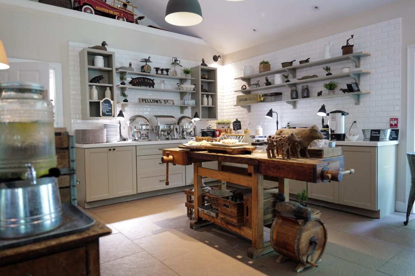 Vintage-style kitchen with wooden table and open shelves.