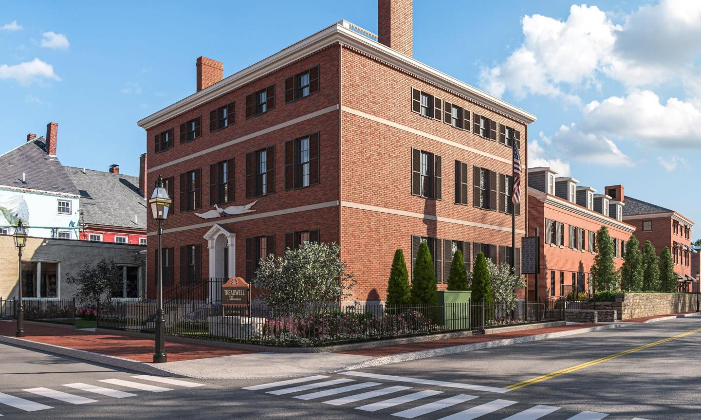 Historic brick building on a sunny street corner with clear sky.