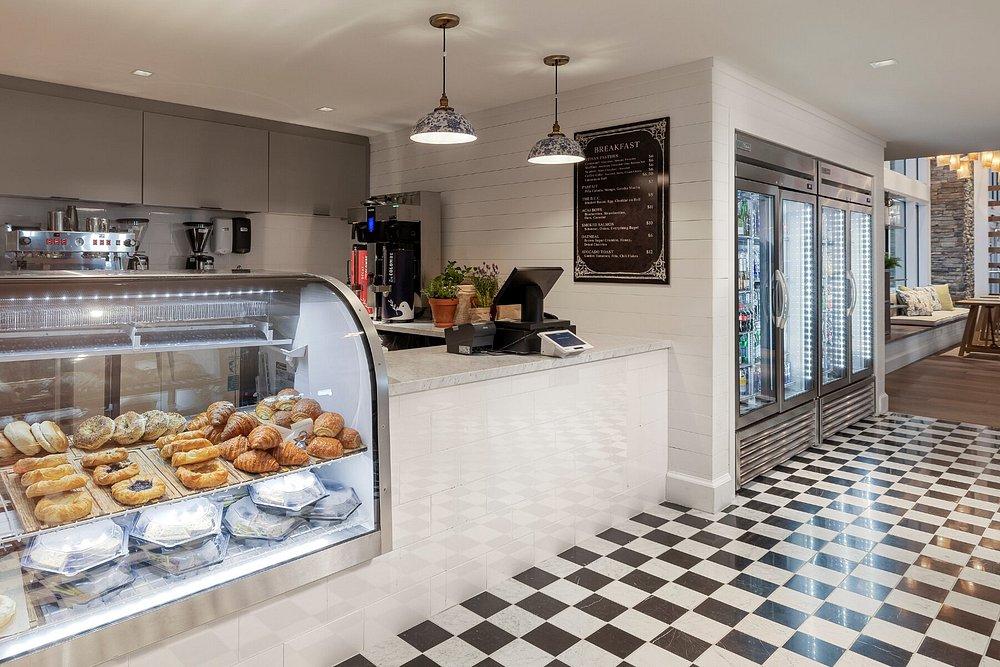 Pastry shop with desserts, checkered floor, and refrigerated display.