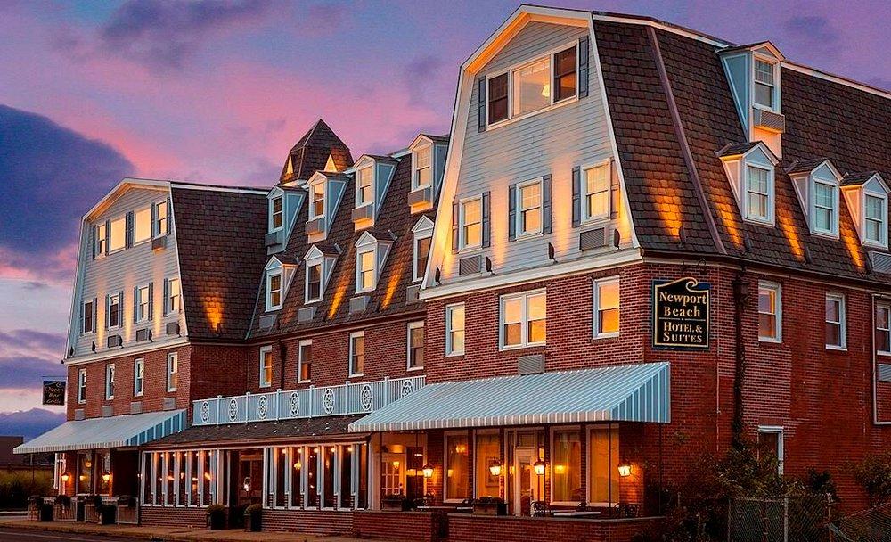Historic hotel at sunset with warm lights and a mansard roof.