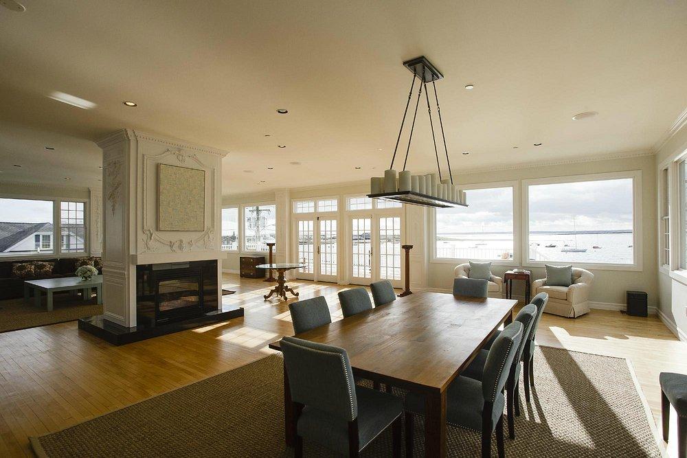 Spacious dining room with large windows and a view of the water.