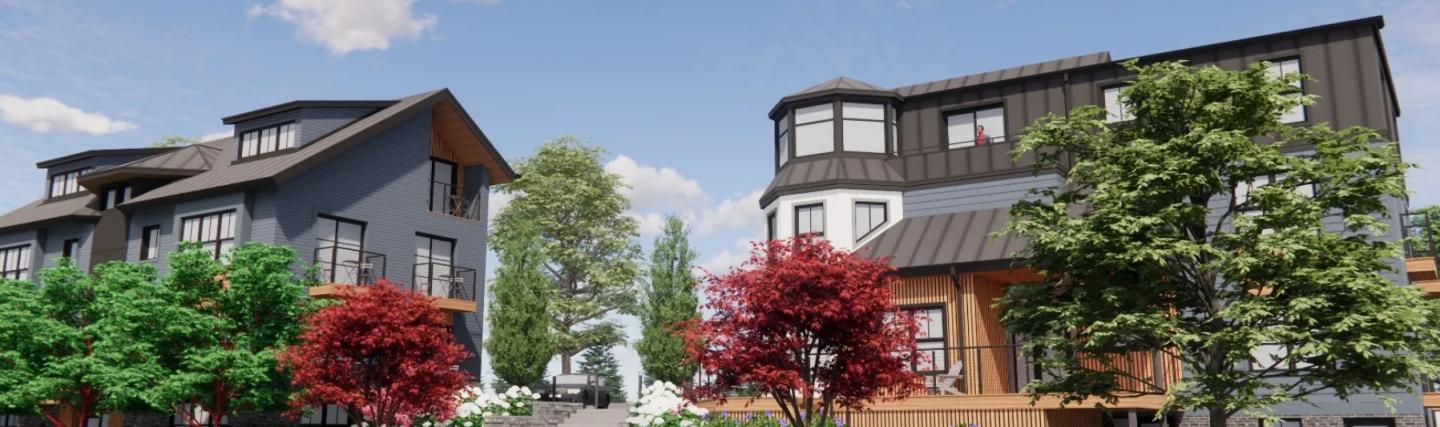 Modern townhouses with lush trees and blue sky.