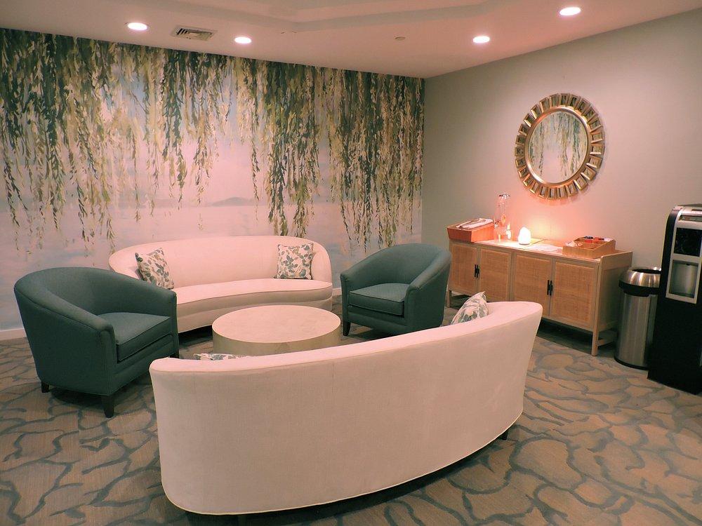 Cozy waiting room with a sofa, armchairs, and a coffee table.