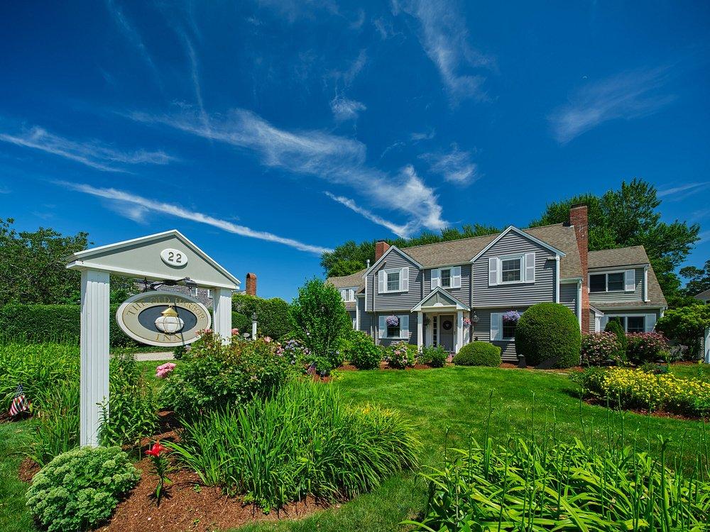 Charming house with lush garden under a vibrant blue sky.