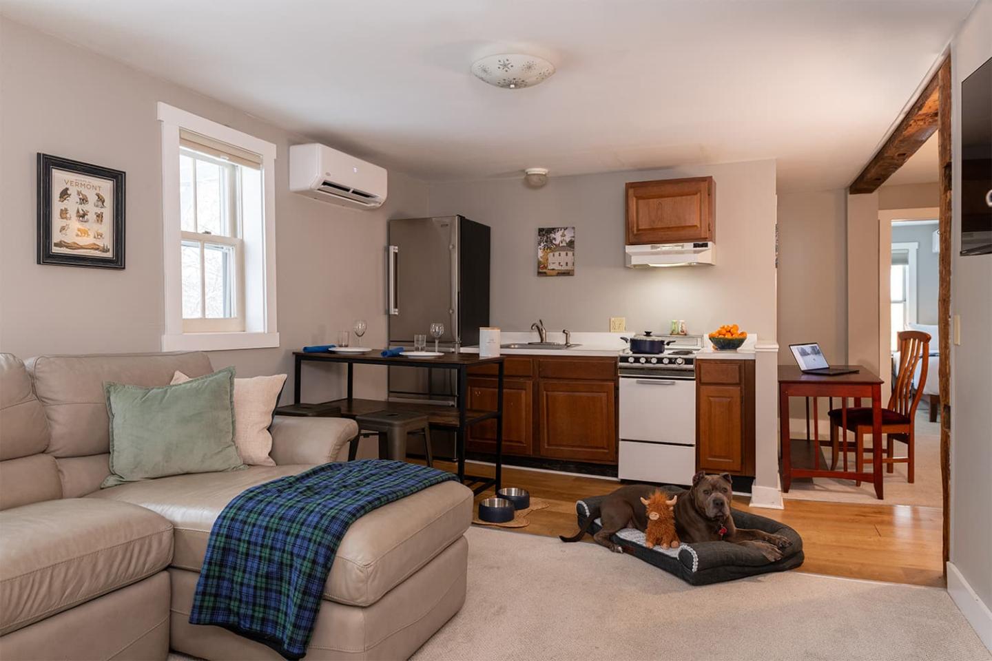 Cozy studio apartment with a kitchenette and a small dining area.