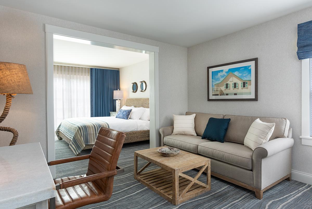 Cozy living room with beige sofa, armchair, coffee table, and blue accents.
