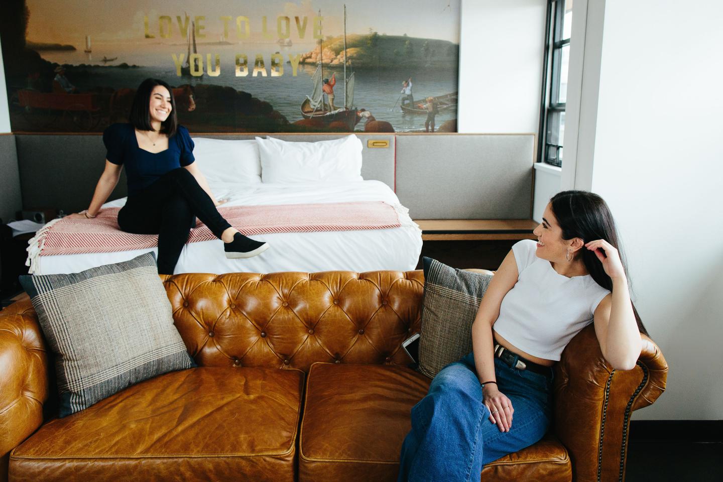 Two women sitting in studio loft at The Revolution Hotel