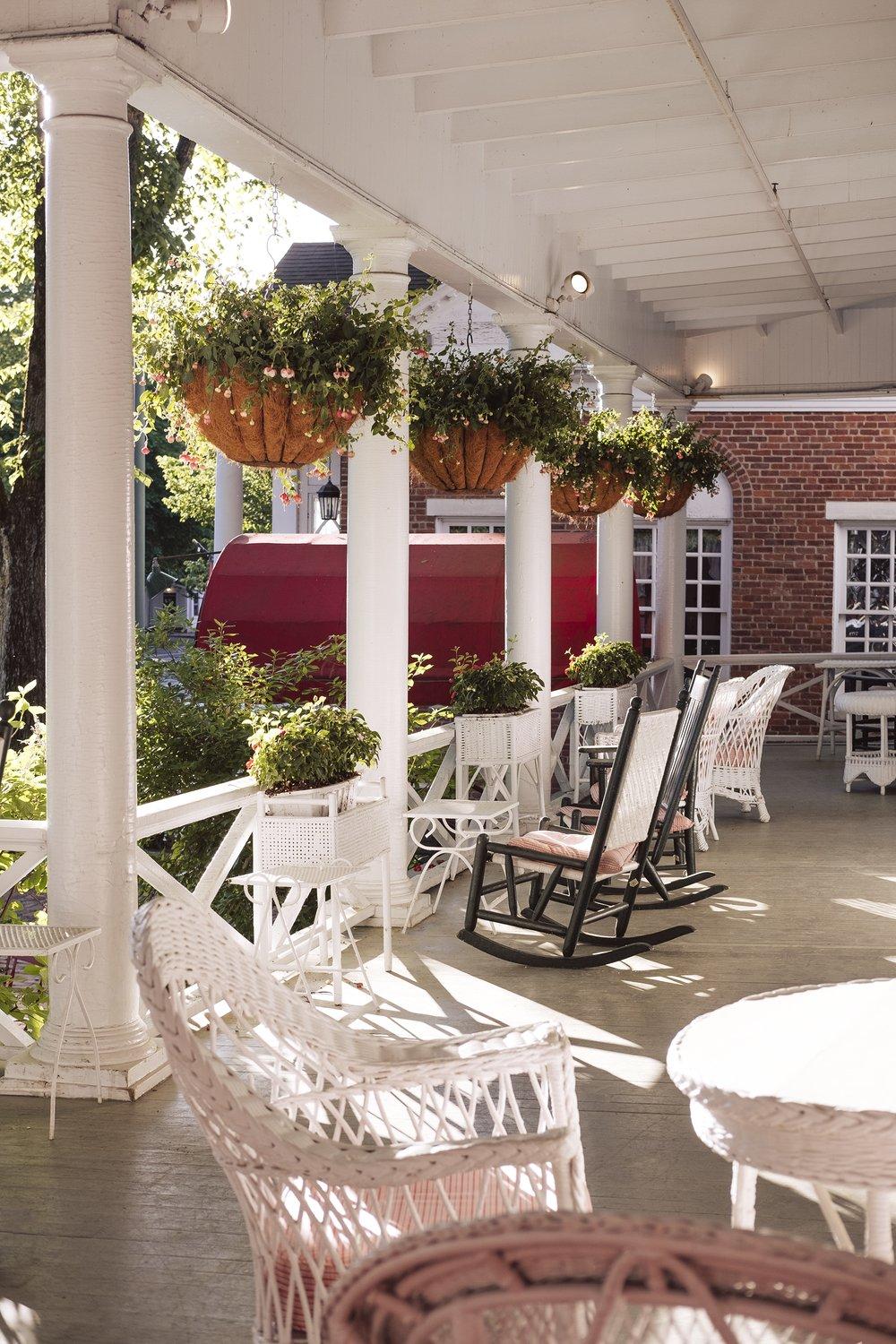 Porch with chairs and hanging flower baskets