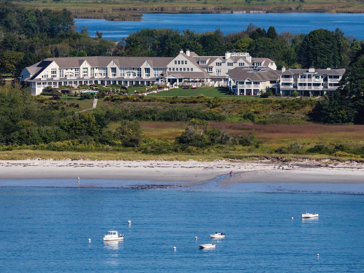 view of beautiful lodge on the beach with ocean in the foreground